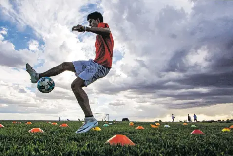  ?? GABRIELA CAMPOS/THE NEW MEXICAN ?? St. Michael’s senior Justice Johnson practices Tuesday at the Municipal Recreation Complex. Johnson is a defensive midfielder for the soccer team as well as a runner on the cross-country team.