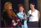  ?? JOHN FLAVELL — THE DAILY INDEPENDEN­T VIA AP ?? From left, Wynonna, Naomi and Ashley Judd appear during Wynonna's concert in Ashland, Ky., in 2002.