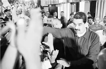  ??  ?? Maduro greets supporters during a meeting in Caracas. — Reuters photo