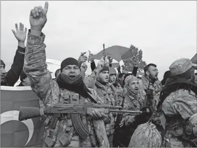  ?? [FURKAN ARSLANOGLU/DEPO PHOTOS] ?? Turkey-backed Free Syrian Army fighters shout slogans before heading toward the Syrian border on Sunday. Turkish troops and Syrian opposition forces attacked a Kurdish enclave in northern Syria in their bid to drive a U.S.-allied Kurdish militia from...