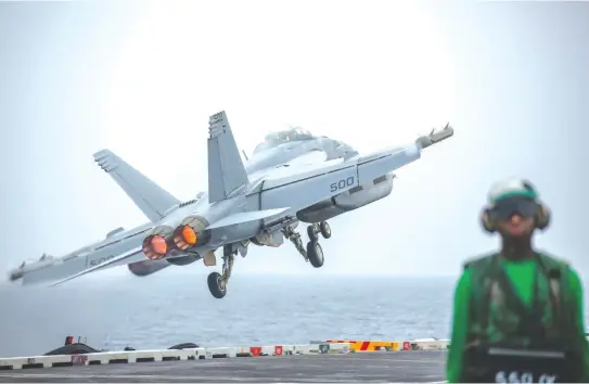  ?? (Reuters) ?? WILL TRUMP BLINK? An EA-18G Growler launches off the flight deck of the ‘USS Abraham Lincoln’ in the Gulf.