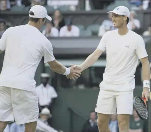  ?? Picture: Ian Rutherford ?? Scotland’s Jamie Murray, right, shakes the hand of John Peers, his Australian playing partner for the last two and a half years, after the pair beat Jonathan Erlich and Philipp Petzschner to book their place in the men’s doubles final at Wimbledon...