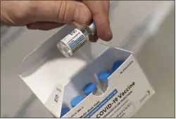  ?? MARK LENNIHAN — THE ASSOCIATED PRESS ?? A pharmacist holds a vial of the Johnson & Johnson Covid-19vaccine at a hospital in Bay Shore, N.Y. About 17 million Americans received the vaccine during the past year it was available.