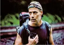  ??  ?? Above: Sebastian Junger heads west along the Juniata River somewhere west of Duncannon, Pa. in 2013. Left: Junger looks for a place to spend the night during a rainstorm west of Bolivar, Pa.