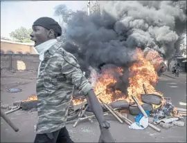  ?? SOPHIE GARCIA — THE ASSOCIATED PRESS ?? Protesters take to the streets of Burkina Faso’s capital Ouagadougo­u on Saturday, calling for President Roch Marc Christian Kabore to resign.