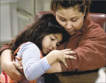  ?? Photograph­s by Francine Orr Los Angeles Times ?? BLANCA, 31, right, cuddles with her daughter Kimberly, 5, at a motel leased by L.A. Family Housing. The mother of five, whose family had been on the move for years, has faced backlash for having so many kids.