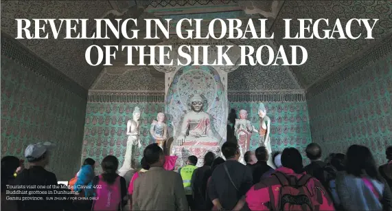  ?? SUN ZHIJUN / FOR CHINA DAILY ?? Tourists visit one of the Mogao Caves’ 492 Buddhist grottoes in Dunhuang, Gansu province.