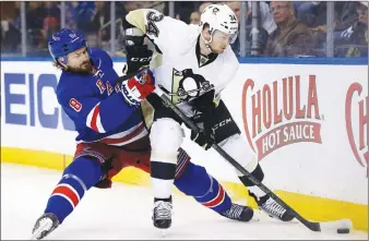  ?? AP PHOTO ?? New York Rangers’ Kevin Klein, left, is knocked down while trying to get the puck from Pittsburgh Penguins’ Tom Kuhnhackl during NHL playoff action in New York.