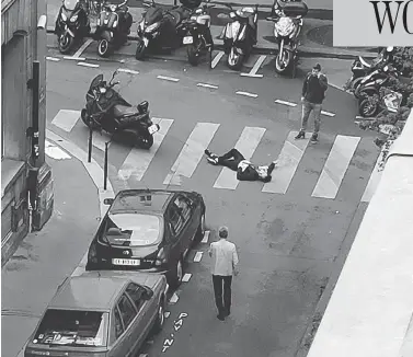  ?? WLADIA DRUMMOND VIA THE ASSOCIATED PRESS ?? A man lays on a street in central Paris Saturday after a stabbing rampage by a 20-year-old Chechen-born man, who was fatally shot by police. The killer was on a police watchlist for radicalism but had a clean criminal record.