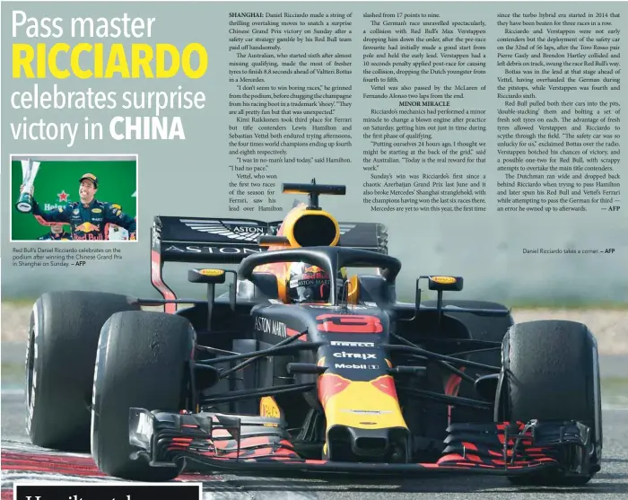  ??  ?? Red Bull’s Daniel Ricciardo celebrates on the podium after winning the Chinese Grand Prix in Shanghai on Sunday. — AFP Daniel Ricciardo takes a corner. — AFP