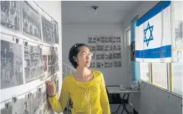  ??  ?? HOW IT WAS: Guo Yan, a tour guide, runs a private museum featuring photos of Kaifeng’s Jewish past near the site of the old synagogue.