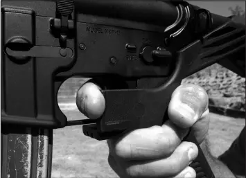  ?? ALLEN G. BREED / ASSOCIATED PRESS FILE (2017) ?? A shooting instructor demonstrat­es the grip on an AR-15 rifle fitted with a “bump stock” at his 37 PSR Gun Club in Bunnlevel, N.C.