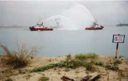  ??  ?? Vessels present a water salute for the installati­on of the final caisson for Tuas Terminal Phase 1 reclamatio­n in Singapore April 23, 2019. (Reuters/Edgar Su)