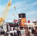  ??  ?? Bikes being hoisted aboard the ferry en route to the Isle of Man.