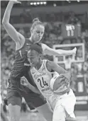  ??  ?? The Storm’s Jewell Loyd (24) drives against the Mercury’s Stephanie Talbot in the second half of Game 1 of the WNBA playoff semifinals Sunday in Seattle.