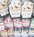  ??  ?? ABOVE Fake eyelashes are displayed for sale at a Daiso store.