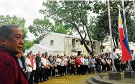  ??  ?? Officials and employees of the Department of Transporta­tion attend their first flag-raising ceremony at the agency's new headquarte­rs in Clark Freeport in Pampanga province on Friday.