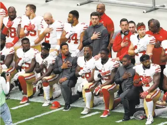  ?? Matt York / Associated Press ?? Some 49ers players kneel during the national anthem as others stand behind them before a game in Glendale, Ariz. The 49ers have been among the most visible NFL teams in their protest.