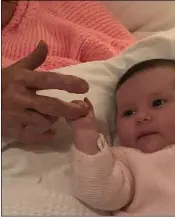  ??  ?? Baby Sofia Maria grips the hand of her greatgreat-grandmothe­r Kitty Walsh.