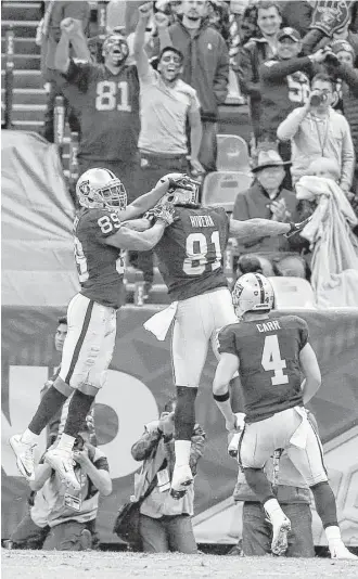  ?? Brett Coomer photos / Houston Chronicle ?? Texans defenders were often missing in action in the fourth quarter, when Oakland’s Amari Cooper (89) and Derek Carr (4) connected on a game-winning 35-yard touchdown pass.