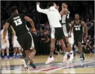  ?? FRANK FRANKLIN II — THE ASSOCIATED PRESS ?? Providence’s Kyron Cartwright (24) celebrates with teammates after beating Xavier in the Big East semifinals Friday in New York.