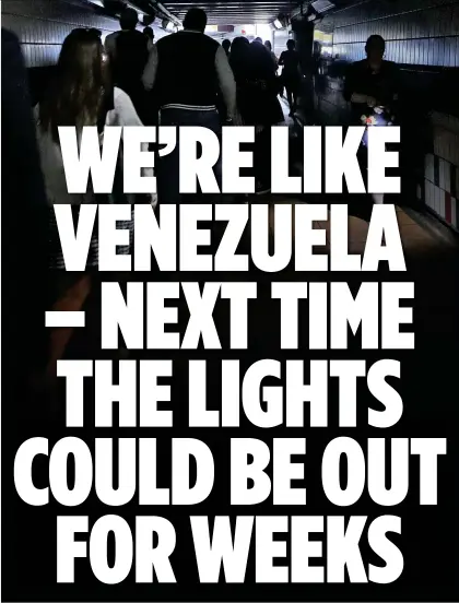  ??  ?? DARKNESS: Britons struggling to make their way home through a railway station subway during Friday’s blackout