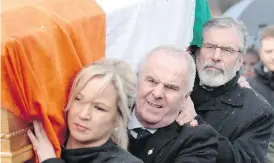  ?? PETER MORRISON / THE ASSOCIATED PRESS ?? Sinn Fein’s Gerry Adams, back, and Michelle O’Neill carry the coffin of Martin McGuinness to the family home in Londonderr­y, Northern Ireland, on Tuesday.