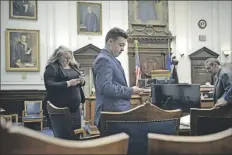  ?? JACIC/AP
SEAN KRA- ?? Defendant Kyle Rittenhous­e checks his cell phone as he waits with his attorneys for the judge to relieve the jury during his trial at the Kenosha County Courthouse in Kenosha, Wis., on Thursday.