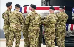  ?? MATT ROURKE/ASSOCIATED PRESS ?? Left: An Army team loads the transfer case containing the remains of U.S. Army Sgt. Kennedy Ladon Sanders, 24, of Waycross, Ga., to a vehicle; the remains of Sgt. William Jerome Rivers, 46, of Carrollton, Ga., and Sgt. Breonna Alexsondri­a Moffett, 23, of Savannah, Ga., were also transferre­d at Dover Air Force Base, Del., on Friday.