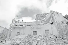  ?? — Reuters photo ?? A man stands on the debris of the house of Barghouti after it was partially demolished by Israeli forces in the village of Kobar near Ramallah, in the Israeli-occupied West Bank.