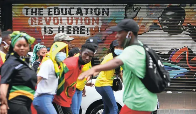  ?? Picture: Alaister Russell ?? Students sing struggle songs as they march through the streets of Braamfonte­in, Johannesbu­rg, last month. The protest was against the financial exclusion of those students who have historical debt and are being denied registrati­on.