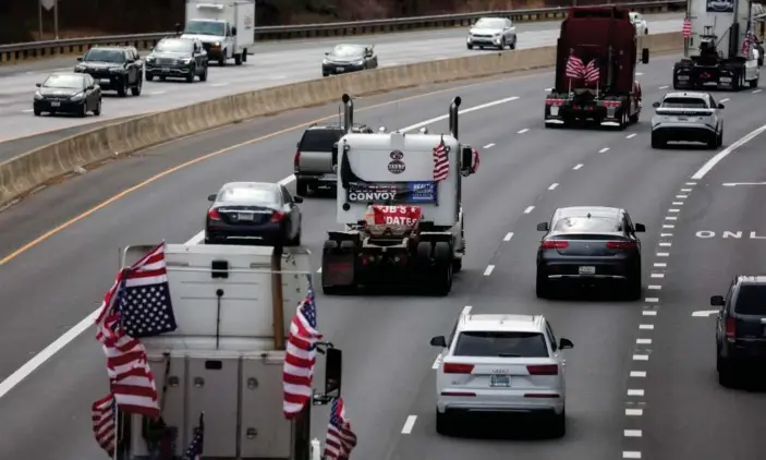  ?? Photograph: Leah Millis/Reuters ?? Truckers and their supporters make their way to drive around the Washington DC beltway, on Sunday.