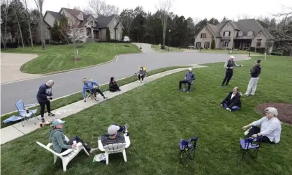  ?? Photograph: Mark Humphrey/AP ?? Neighbors have an informal gathering while keeping a safe distance because of the coronaviru­s on 22 March 2020, in Nolensvill­e, Tennessee.