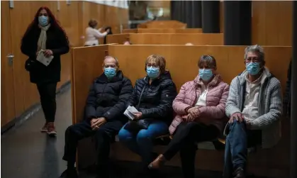  ?? Emilio Morenatti/AP ?? People wearing face masks inside a hospital in Barcelona on Monday, amid an outbreak of respirator­y illnesses in Spain. Photograph: