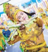  ??  ?? A dancer performs during the Kalap Festival street dance tilt (above left). A parade float celebrates 20 years of Calapan’s cityhood (above right).