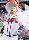  ?? DANIEL SHIREY, US PRESSWIRE ?? Freddie Freeman gets doused Tuesday after his ninth-inning homer.