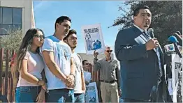  ?? ASTRID GALVAN/AP ?? Guadalupe Garcia de Rayos’ family stands with her attorney, Ray Ybarra Maldonado, in front of the ICE office in Phoenix. Two of Garcia de Rayos’ children are U.S. citizens.