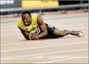  ?? ASSOCIATED PRESS ?? JAMAICA’S USAIN BOLT LIES ON THE TRACK after he injured himself during the 4x100m relay final during the World Athletics Championsh­ips in London on Saturday.