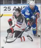  ?? The Associated Press ?? Canada forward Matt Duchene plays the puck from his knees as Slovenia’s Jan Mursak defends during their IIHF World Championsh­ip Group B game in Paris, France on Sunday. Canada won 7-2.