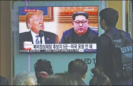  ?? AP PHOTO ?? People watch a TV screen showing file footage of U.S. President Donald Trump, left, and North Korean leader Kim Jong Un at the Seoul Railway Station in Seoul, South Korea yesterday.