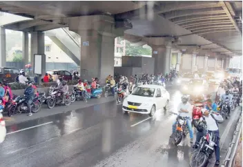  ?? — DC ?? With the city on the clutches of heavy rains, motorists, who are forced to take shelter beneath the metro pillars, don’t seem to care that a lady died a few days ago after a chunk of the plaster peeled off and fell on her.