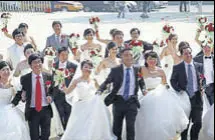  ?? AFP ?? Chinese couples at a mass wedding ceremony in Beijing. An estimated 10 million weddings take place annually.