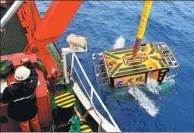  ?? ZHANG XUDONG / XINHUA ?? A remotely operated diving vehicle is launched to explore the Caroline seamount in the western Pacific Ocean on Monday.