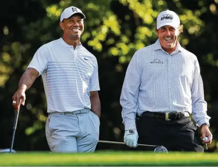  ?? Curtis Compton / Associated Press ?? As they’ve gotten older, Tiger Woods, left, and Phil Mickelson have become better friends. Another byproduct of age has been the difficulty of contending in major championsh­ips, but that may not apply at Augusta as Woods showed when winning in 2019.