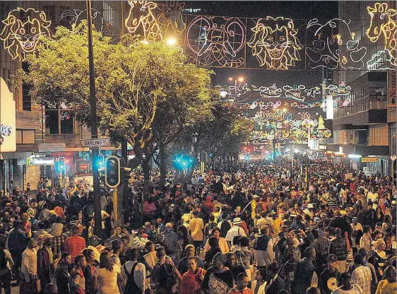  ??  ?? CHEERFUL CROWD: Thousands of people pack Adderley Street for the Cape Town Festival of Lights last year during the holiday season.