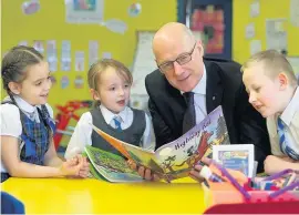  ??  ?? A good read John Swinney reading with Our Lady of Peace Primary School P3 pupils Lily Matthews, Cara McIntyre and Andrew Deans, all aged 7.