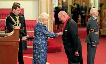  ?? PHOTO: GETTY IMAGES ?? Lord Geidt receives one of his many honours from the Queen.