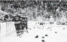  ?? WINSLOW TOWNSON THE ASSOCIATED PRESS ?? Hats litter the ice after David Pastrnak’s third goal Saturday. The Bruins sniper added three assists in a 7-3 whipping of the Leafs in Boston.