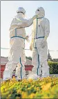  ?? AFP ?? Health care workers prepare for work in the Burmese city of Mandalay.