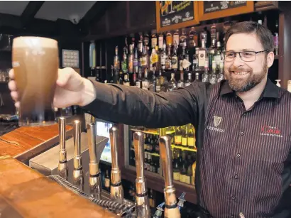  ?? PHOTO: PETER MCINTOSH ?? Up and running again . . . Bruce Hoffman, duty manager at Craic in the Octagon, pours a beer yesterday.